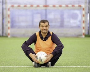 Male HHD patient holding a football