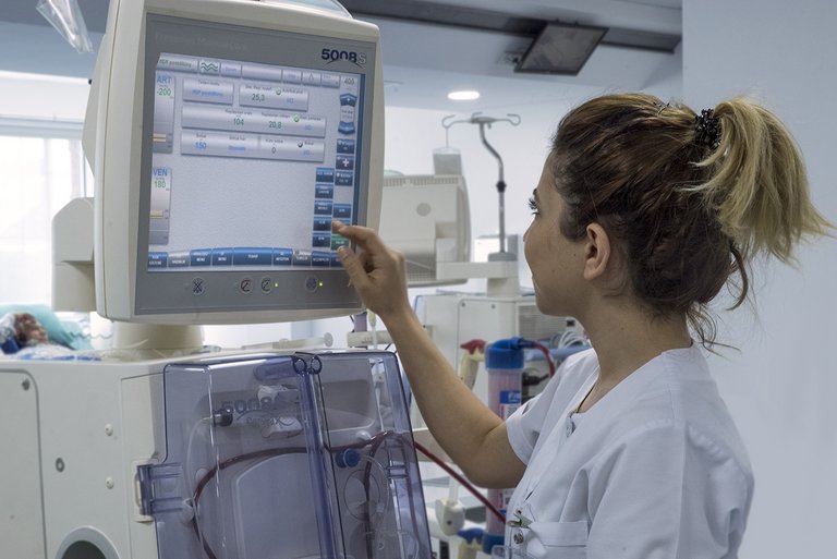 Nurse working on a dialysis machine